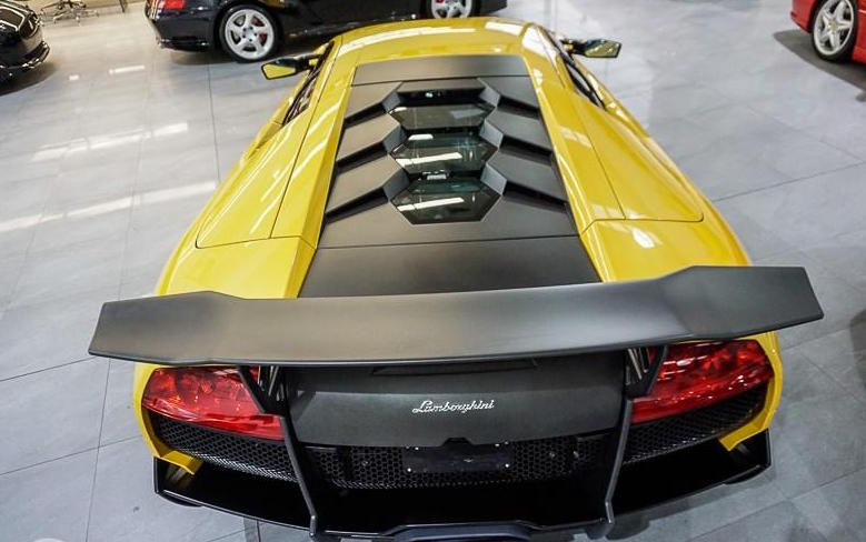 Rear Photo of Yellow Lamborghini Murcielago 670-4 SV with Black Wing and Engine Cover