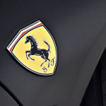 Ferrari yellow badge on black background